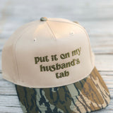 Put It On My Husbands Tab Trucker Hat