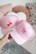 COQUETTE BOW EMBROIDERED TRUCKER HAT
